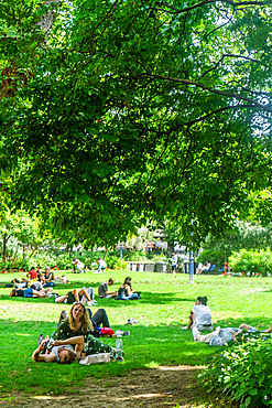 People on lawn of Suare Saint-Jaques on sunny day in summer