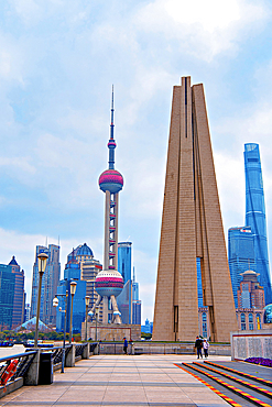 The Shanghai People's Heroes Memorial Tower (right), commemorating those who fought for their homeland in wars and natural disasters and The Oriental Pearl Tower (left). Shanghai, China.
