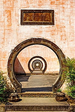 A series of outdoor circular doorways, Chengkan Ancient Village. The village was established 1800 years ago by the Luo family clan. It has buildings dating as early as the Song Dynasty (960 to 1279 AD). Huangshan City, Anhui, China.