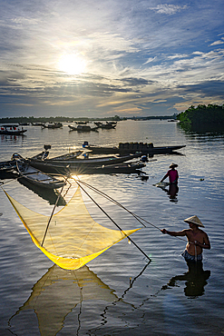 Traditional fishermen using nets at sunrise, Hue, Thua Thien-Hue province, Central Vietnam. (MR)