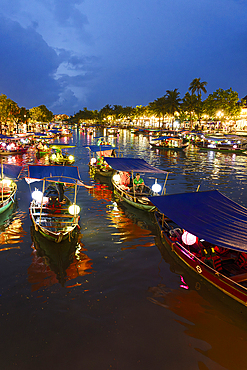Boats floating on the Thu Bon River at dusk in Hoi An Old Town, Quang Nam Province, Vietnam