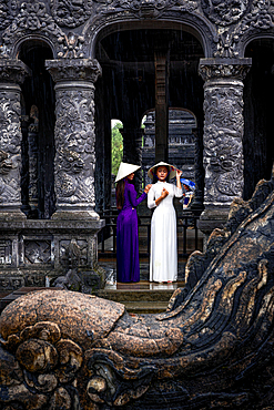 Women in ao dai and conical hat at Khai Dinh Tomb, Hue, Central Vietnam. (MR)