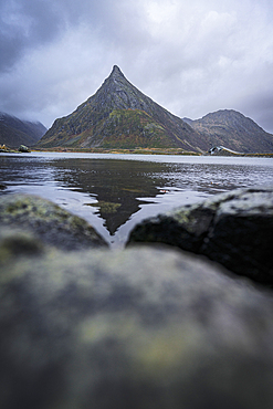 Volanstinden mountain peak reflected in a fjord, Fredvang, Lofoten Islands, Norway