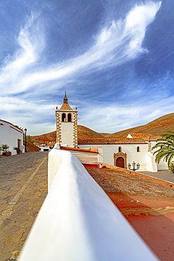 Clouds over the old whitewashed bell tower of the Church of Saint Mary, Betancuria, Fuerteventura, Canary Islands, Spain