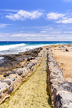 Sea water enterint the salt flats tanks, Las Salinas del Carmen, Fuerteventura, Canary Islands, Spain