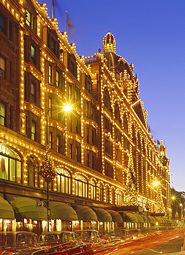 Harrods store illuminated in the evening, Knightsbridge, London, England, UK