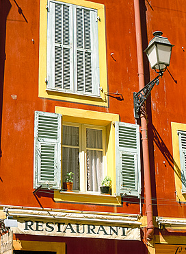 Architectural detail of lamp and shuttered windows above a restaurant awning, Old Town, Nice, Alpes Maritimes, Provence, French Riviera, France, Europe