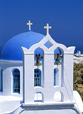 Close-up of white walls and bells in bell tower with blue dome behind at a church in Apollonia, on Sifnos, Cyclades, Greek Islands, Greece, Europe