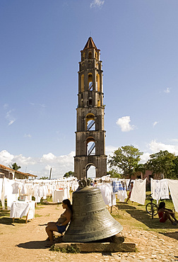 Hand crafted linens for sale beside the Manaca Iznaga Estate Tower and a bell which used to be rung to announce work hours for slaves on the plantation, Valle de los Ingenios, Eastern Cuba, Cuba, West Indies, Central America