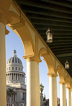 A view of the Capitolio seen through the arches of a colonial style arcade in central Havana, Cuba, West Indies, Caribbean, Central America