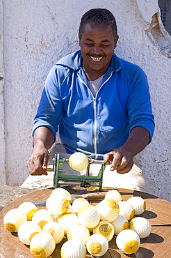 A Cuban man peeling oranges to sell, Havana, Cuba, West Indies, Central America