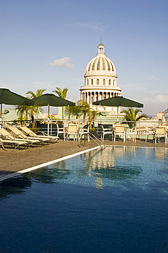 A swimming pool on the roof terrace of the Hotel Saratoga overlooking the Capitolio in central Havana, Cuba, West Indies, Central America