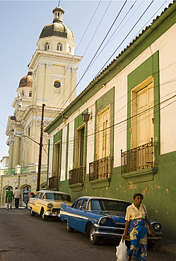 Vintage cars parked in an old street past vintage cars near the Catedral de la Asuncion, Santiago de Cuba, Cuba, West Indies, Central America