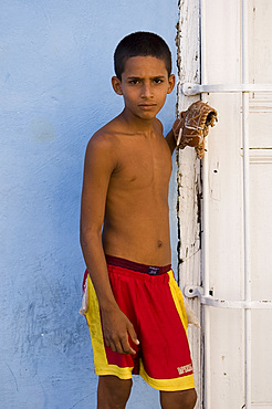 A young Cuban boy with a baseball mitt in Trinidad, Cuba, West Indies, Central America