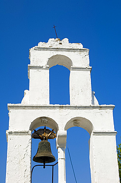 The whitewashed belltower of Agios Dimitrios against a clear blue sky, Paxos, Ionian Islands, Greek Islands, Greece, Europe