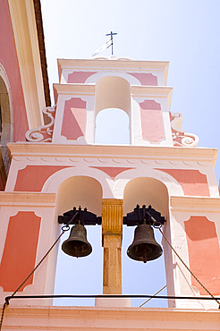 The pink and white belltower of Agios Triada in Gaios, Paxos, Ionian Islands, Greek Islands, Greece, Europe