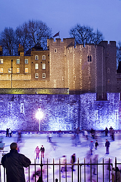 Skaters on the ice rink next to The Tower of London at dusk, London, United Kingdom, Europe