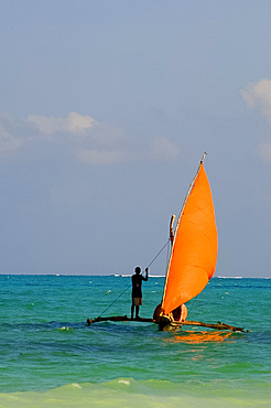 A traditional wooden dhow with an orange sail, Paje, Zanzibar, Tanzania, East Africa, Africa