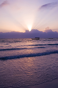 An old wooden boat in the sea at sunrise, Paje, Zanzibar, Tanzania, East Africa, Africa