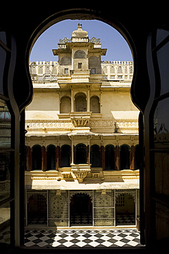 A section of The City Palace viewed through an arched window, Udaipur, Rajasthan, India, Asia