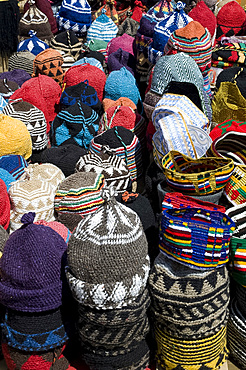 Brightly coloured knitted wool hats for sale in the souk in Marrakech, Morocco, North Africa, Africa