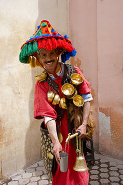 A water seller dressed in traditional colourful Berber dress in Marrakech, Morocco, North Africa, Africa