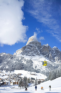 A view toward the town of Corvara and gondola at the Alta Badia ski resort with Sassongher Mountain behind, Dolomites, South Tyrol, Italy, Europe