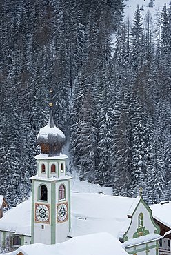 The Church of San Cassiano and snow covered trees behind, San Cassiano, Dolomites, South Tyrol, Italy, Europe