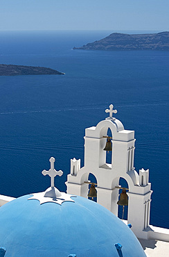 A blue domed Greek Orthodox church overlooking the sea in Firostefani, Santorini, The Cyclades, The Aegean, Greek Islands, Greece, Europe