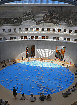 Fondation Pinault in La Bourse de Commerce, Paris. The circular central structure and pool designed by Tadao Ando set within the Bourse originally used to trade wheat and other commodities below the glass dome ceiling and mural of the four seasons.
