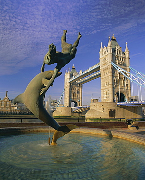 Fountain of child with dolphin and Tower Bridge, London, England, UK, Europe