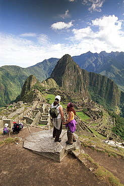 Tourists looking out over the ruins of the Inca site, Machu Picchu, UNESCO World Heritage Site, Urubamba Province, Peru, South America