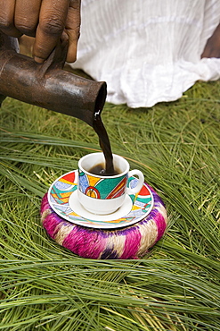 Pouring coffee during a coffee ceremony, Ethiopia, Africa