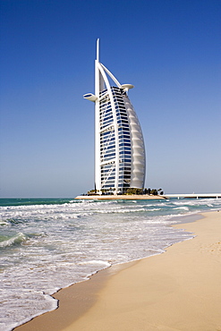 The iconic symbol of Dubai, the Burj Al Arab, the world's first seven star hotel (classified as five star deluxe), built on an artificial island offshore from the Jumeirah Beach Hotel, Dubai, United Arab Emirates, Middle East