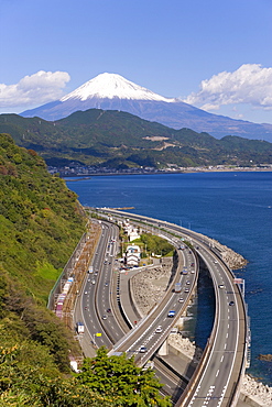 Elevated view over Expressway running along the Pacific coast, and Mount Fuji capped in snow beyond, Fuji-Hakone-Izu National Park, Chubu, Central Honshu, Japan, Asia