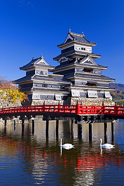 Matsumoto-jo (Matsumoto Castle), the three-turreted donjon built in 1595 in contrasting black and white, surrounded by a moat with access across ornate red bridges, Matsumoto, Nagano Prefecture, Chubu, Central Honshu, Japan, Asia