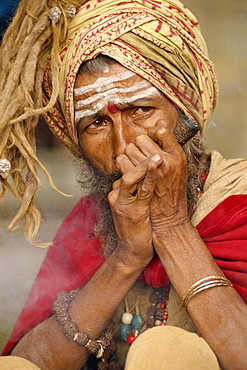 Portrait of a Sadhu or holy man smoking a pipe, in Kathmandu, Nepal, Asia