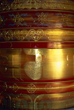 Large gold and red spinning Buddhist prayer wheels at Bodhnath Stupa in Kathmandu, Nepal, Asia