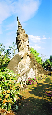 Reclining Buddha statue in the open at Xieng Khuan, Vientiane, Laos