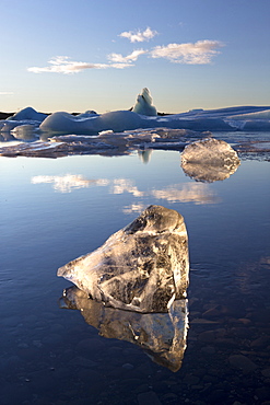 View of icebergs on Jokulsarlon, a glacial lagoon at the head of the Breidamerkurjokull Glacier, with some icebergs illuminated by the afternoon winter sun, on the edge of the Vatnajokull National Park, South Iceland, Iceland, Polar Regions