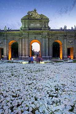 Puerto de Alcala at dusk and white flowerbed, Madrid, Spain, Europe