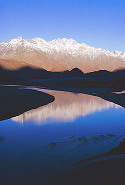 The Indus River at Skardu (2,300m), Baltistan.  Looking upstream with Masherbrum Range of the Karakorum in background, Pakistan