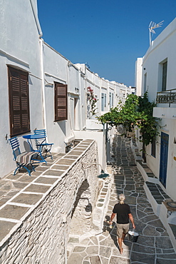 Man with paint walking through traditional Greek houses, Kastro Village, Sifnos, Cyclades, Greek Islands, Greece, Europe