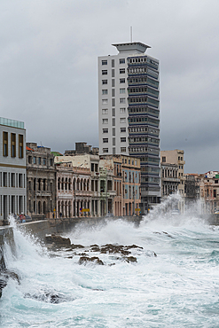 Storm waves batter the seafront Malecon with its faded grandeur stucco houses on Malecon, Havana, Cuba 1