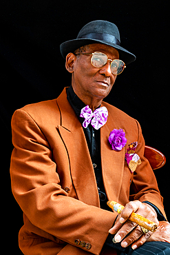 Man seated dressed as 1950s dandy/gangster with fedora hat and big cigar, Havana, Cuba 1 (Model Release)