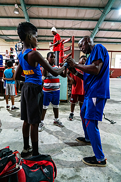 Young boxer being gloved up by trainer, Boxing Academy Trejo, Havana, Cuba