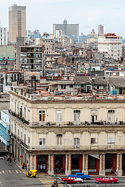 Aerial view of the dividing streets between Modern and Old Havana, classic cars in foreground, Cuba 4