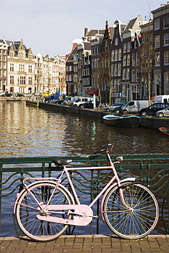 Old pink bicycle by the Herengracht canal, Amsterdam, Netherlands, Europe