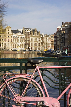 Old pink bicycle by the Herengracht canal, Amsterdam, Netherlands, Europe