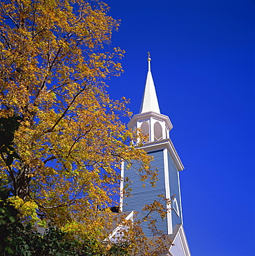 Trees in fall colours and wooden church spire at Wiscasset, Maine, New England, United States of America, North America